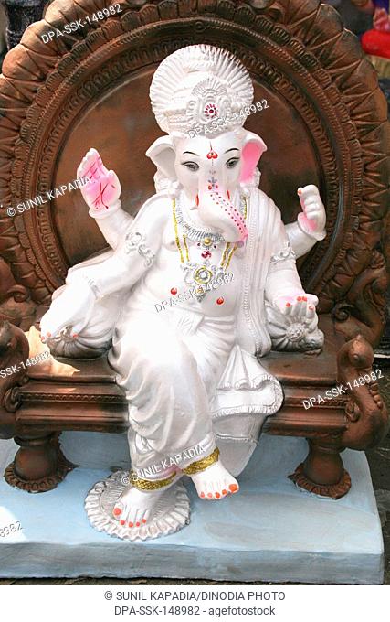 A white shiny idol of lord Ganesh ; the elephant headed god ; Pune ; Maharashtra ; India