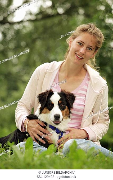 young woman with Australian shepherd puppy