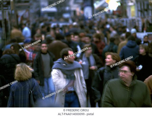 Crowd walking in street, blurred