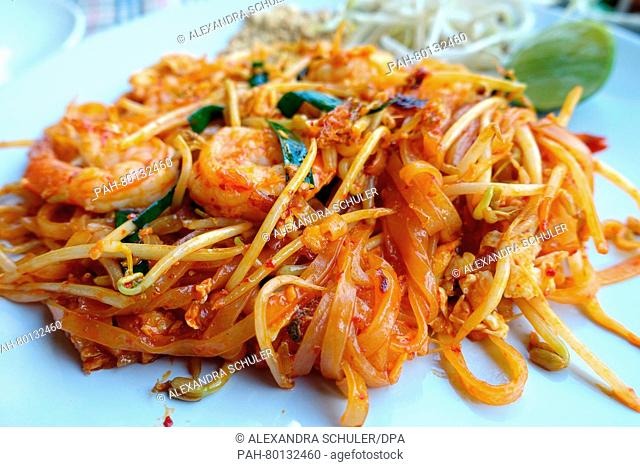A plate of pad thai is seen on a table at a restauarant in Karon Beach, Thailand 12 March 2016. Phat Thai or Pad Thai is a traditional noodle dish of Thai...