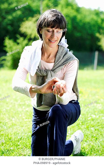 Woman checking her pulse after exercising