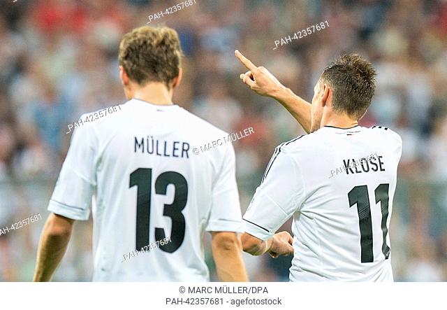 Germany's Miroslav Klose celebrates next to team mate Thomas Mueller after scoring the opening goal during the FIFA World Cup 2014 qualification group C soccer...