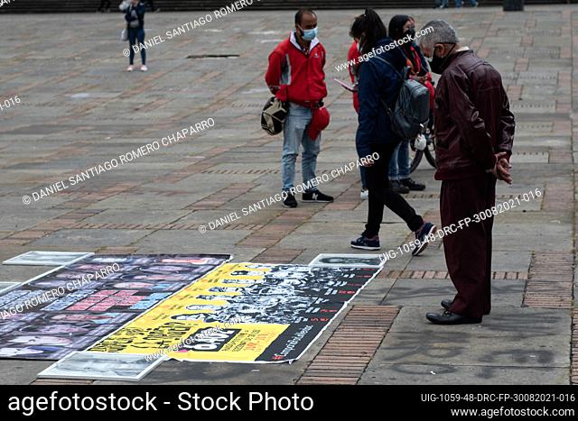 A men looks at the banner of ""Who gave the order"" with images of police and army generals involved in the forced disappearence cases during the commemoration...