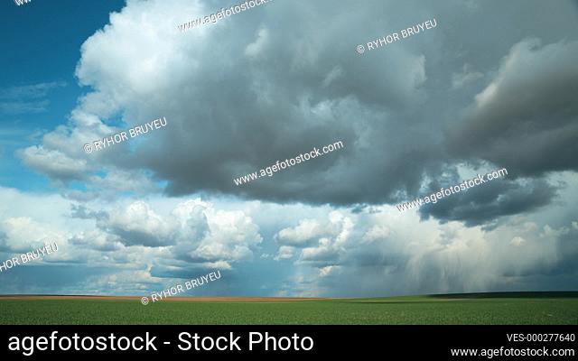Dramatic Sky Before Rain With Rain Clouds On Horizon Above Rural Landscape Field Meadow. Agricultural And Weather Forecast Concept