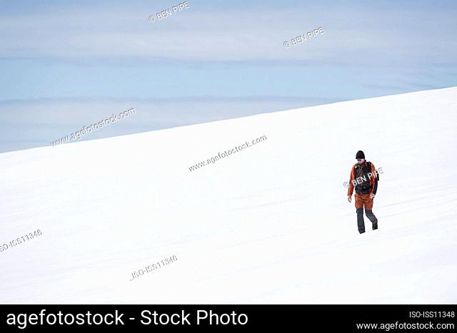 Male hiker walking in snowy mountains