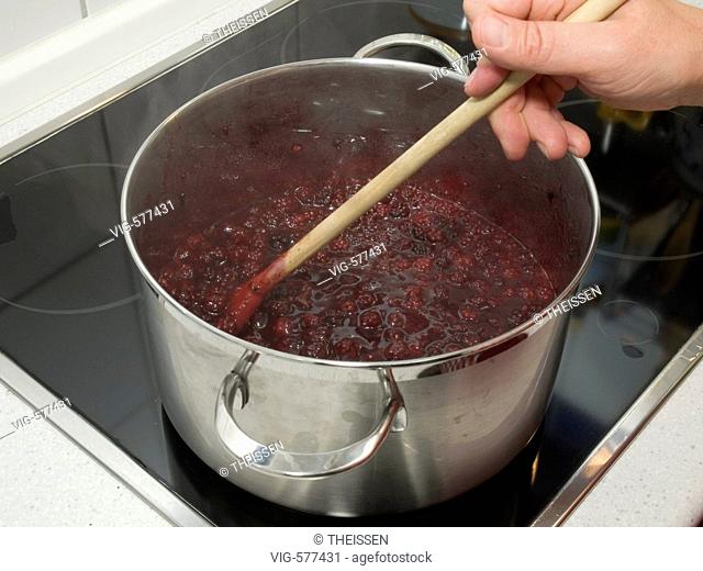 making jam from blueberries in cooking pot on cooker, . - 03/08/2007