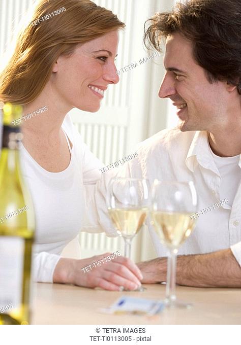 Smiling couple with glasses of wine