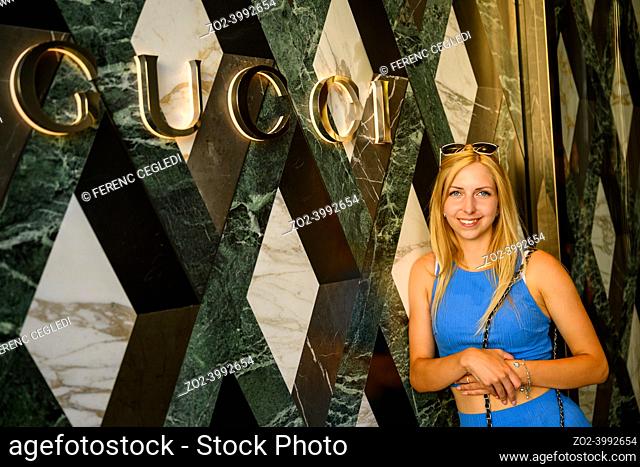Young Female Posing In Front Of Gucci, The Famous Luxury Boutique in Rodeo Drive, Beverly Hills, California, United States Of America
