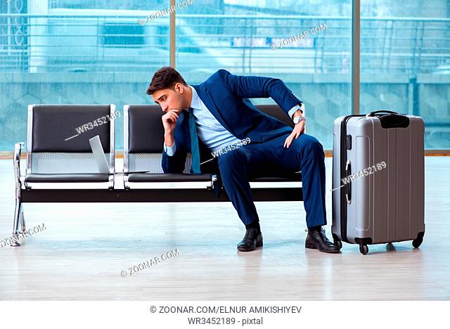 Businessman waiting at the airport for his plane in business class