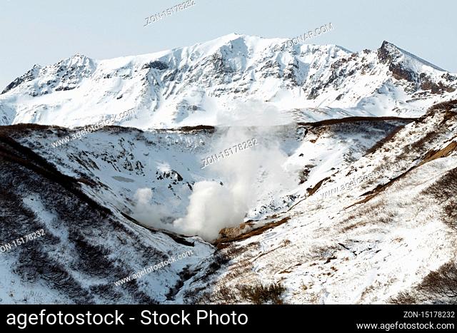 Volcano landscape of Kamchatka Peninsula. Scenery winter view of geothermal valley of Dachnye Hot Springs: popular touristic attraction in volcanic zone of...