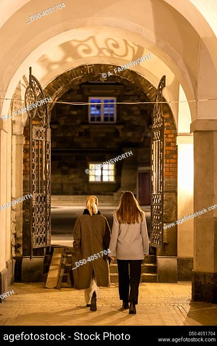 Copenhagen, Denmark People pass an old arched passageway at the Christiansborg Palace, site of government and Parliament