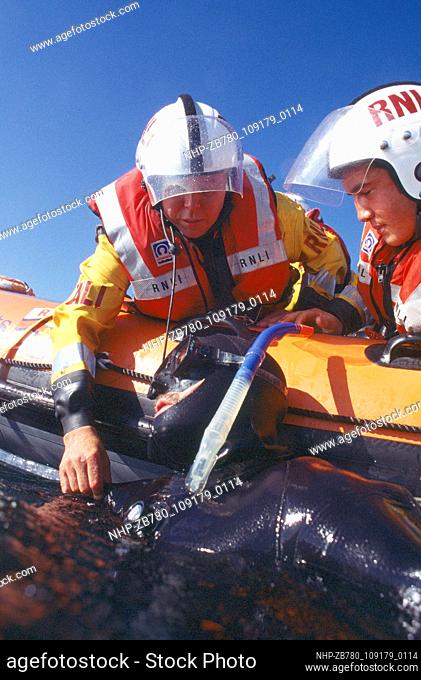 RNLI Crew from Falmouth, UK, practise diver rescue and retrieval from the sea. They work closely with Royal Navy Search and Rescue helicopters and the...