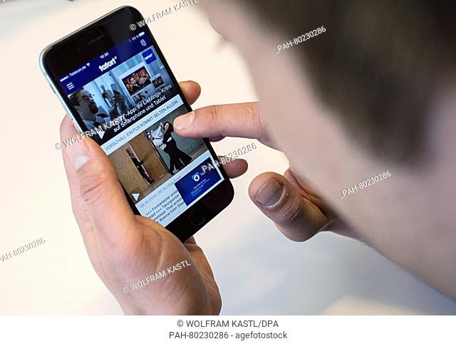 A young man uses the 'Tatort' app on a smartphone in Berlin,  Germany, 09 May 2016. 'Tatort' (lit. Crime scene) refers to a German television crime series...