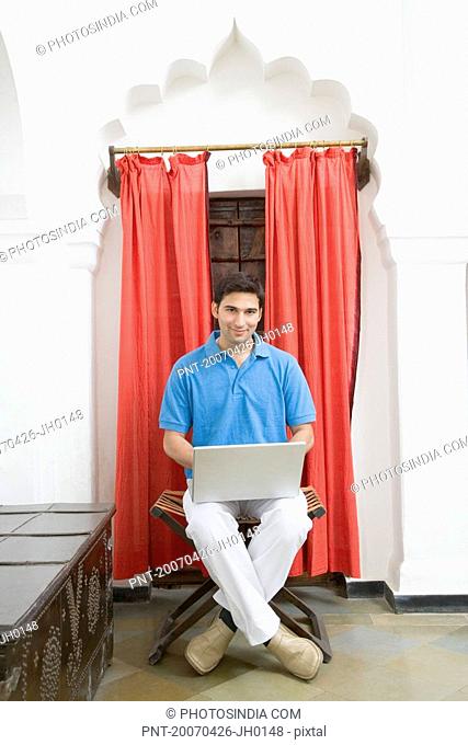 Portrait of a young man using a laptop