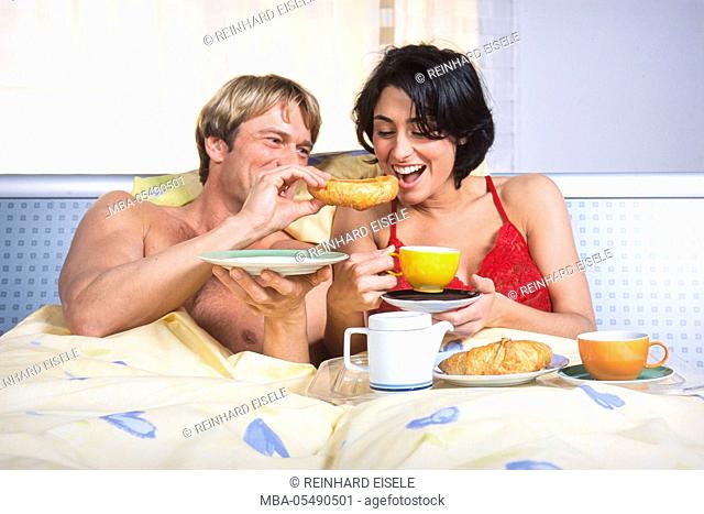 Young couple at the breakfast in the bed
