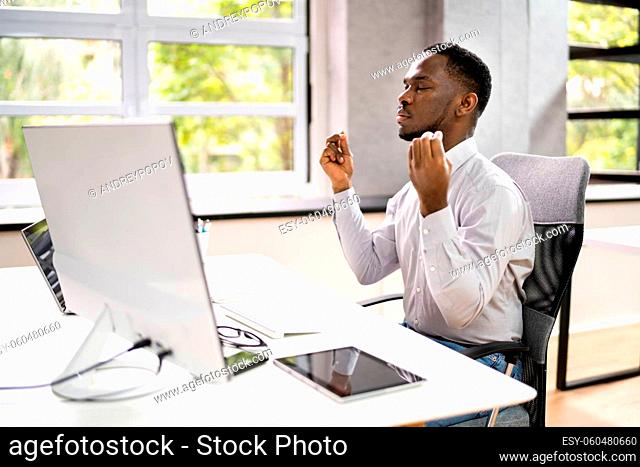 African American Man Meditation Behind Computer In Office