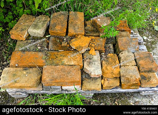 Galder, Netherlands. Old, antique bricks and stones from a farm house waiting to be used for new projects and cosntructions