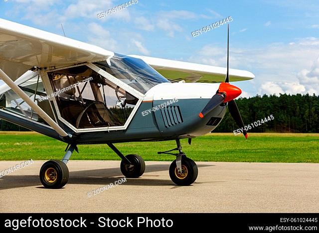 outdoor shot of small plane standing near meadow before take-off. summer season