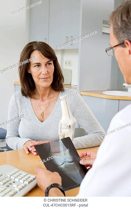 Doctor examining x-rays with patient