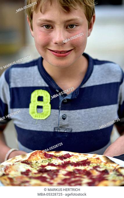 Boy with pizza in Palma de Majorca, Spain, Europe