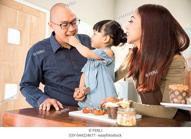 Portrait of family member spending their time together cooking in the kitchen