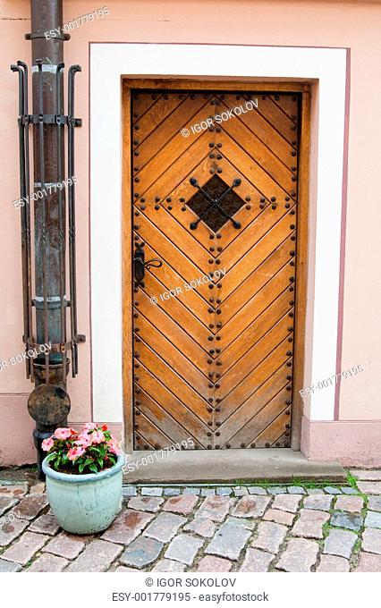 Old door and vase with flowers