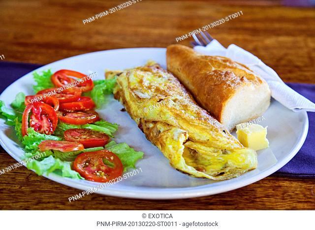 Close-up of a cheese egg roll with salad and bread in a plate, Baba au Rhum Restaurant, Opposite Uttam Resorts, Near Club Cubana, Arpora, Bardez, North Goa, Goa