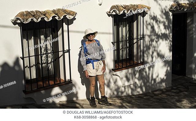 Woman, 66, by a house in Grazalema, Andalucia, Spain, Cadiz province