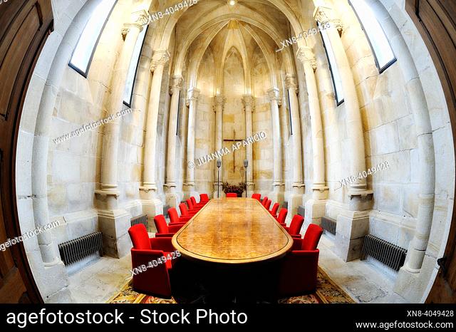 Butron castle room with a large table of meetings on the center surrounded by red upholstered chairs photographed with fisheye