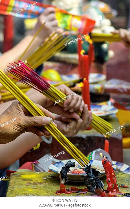 Worshipers burn incense candles at a Chinese temple in Ho Chi Minh City, Socialist Republic of Vietnam