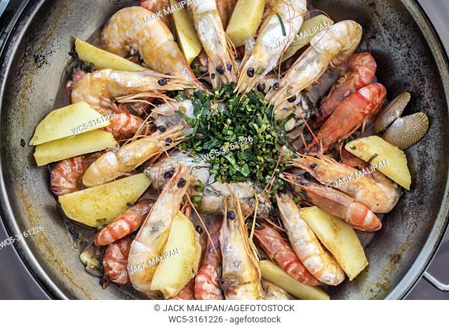 prawn fish seafood stew in garlic white wine sauce portuguese cataplana style
