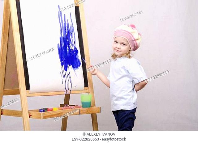 Girl artist paints on canvas