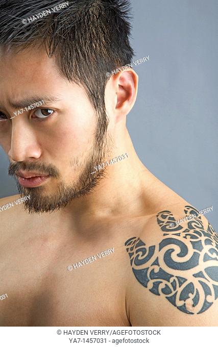 Close Up Of Face Of Chinese Man with Tattoo