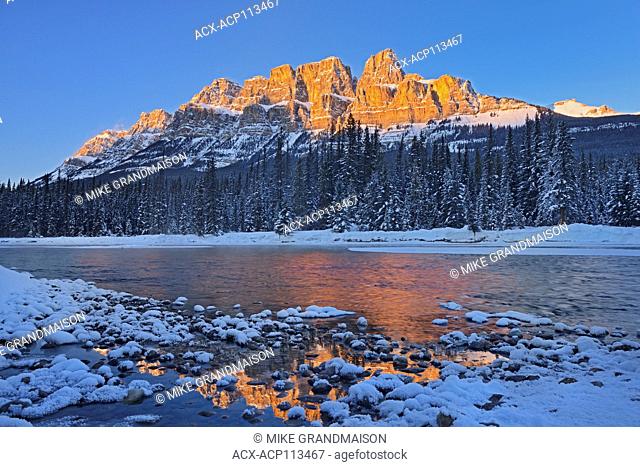Castle Mountain reflected in the Bow River. at sunset. Castle Junction, Banff National Park, Alberta, Canada