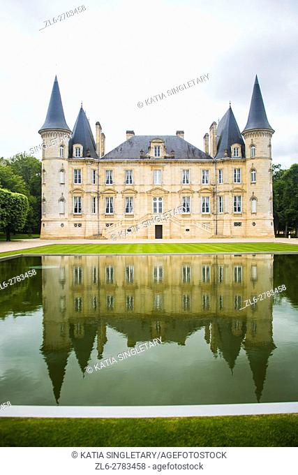 Château Pichon Longueville Baron in the wine region of Medoc in France. The castle reflects in the little lake in front of it