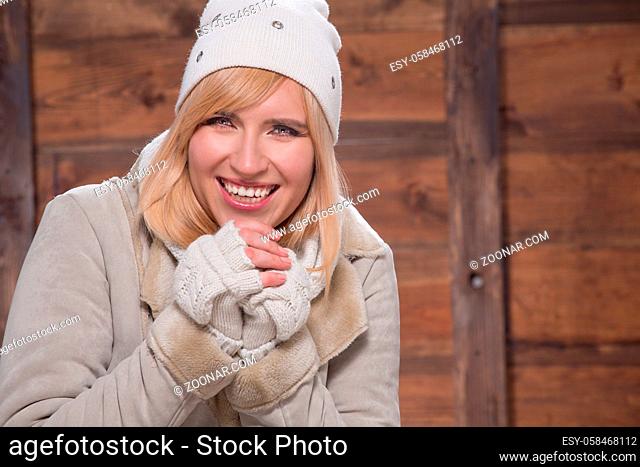 Smiling young woman in wear for cold weather