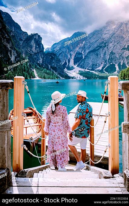 couple visit the famous lake Lago Di Braies Italy, Pragser Wildsee in South Tyrol, Beautiful lake in the italian alps, Lago di Braies