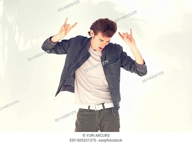 A confident hipster male showing hand signals and looking downwards