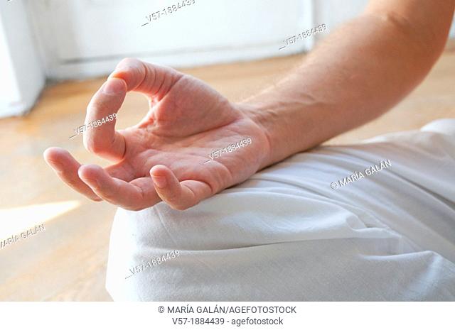 Spain, Man practicing yoga Asana,  sitting in lotus position