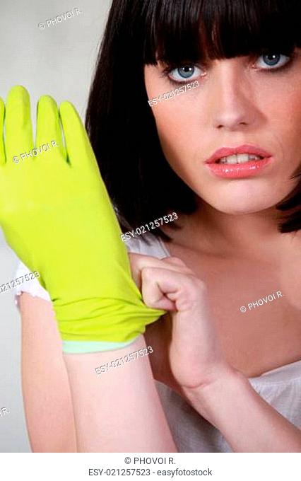 Woman putting on rubber gloves