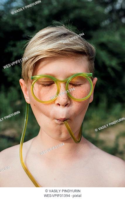 Portrait of freckled boy with funny glasses