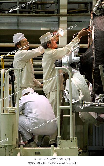 At the Baikonur Cosmodrome in Kazakhstan, RSC Energia personnel prepare the Soyuz TMA-20 spacecraft docking mechanism before the vehicle's encapsulation into...