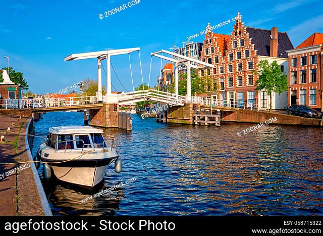 Spaarne river with boat and Gravestenenbrug bridge famous tourist landmark in Haarlem, Netherlands