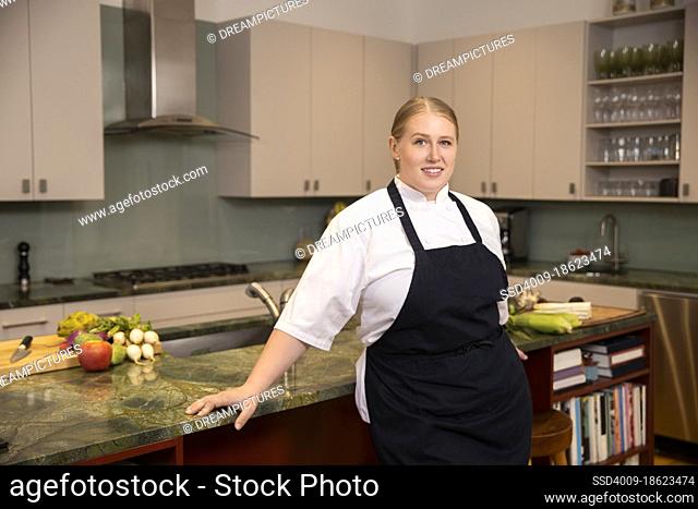 Portrait of Chef Megan Gill in home kitchen looking at camera