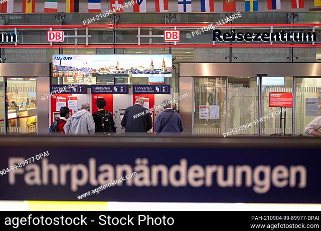 04 September 2021, North Rhine-Westphalia, Dortmund: Rail customers stand in front of a ticket vending machine. The train drivers' union GDL is striking...