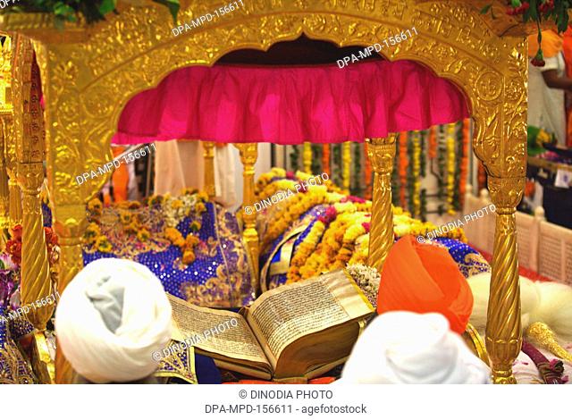 Sikh cleric reading scriptures ; celebrations of 300th year of consecration of perpetual Guru Granth Sahib ; Sachkhand Saheb Gurudwara in Nanded ; Maharashtra ;...