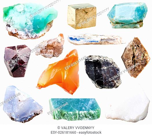 collection of natural mineral crystal gemstones - nephrite, kyanite, garnet (almandine), pyrite, schorl (black tourmaline), topaz, zircon in rock, chalcedony