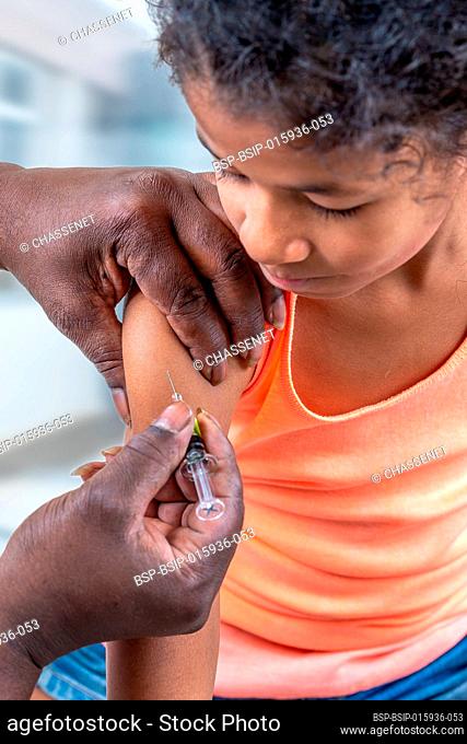 Little suspicious girl get an injection, vaccination