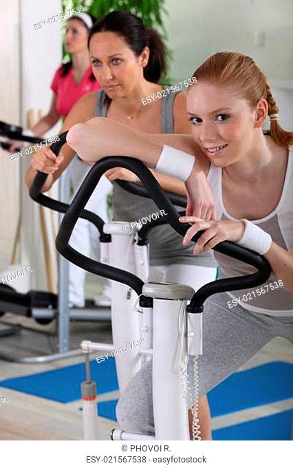 Young women using exercise equipment