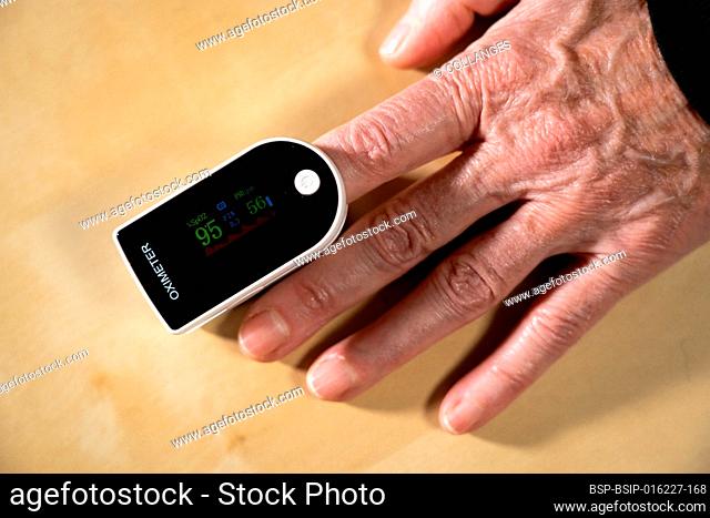Oximeter attached to the index finger to measure the oxygen level in the blood